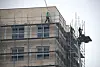Workers work without safety harnesses at a construction site in Seoul in February. [YONHAP]