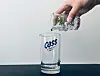 Two soju glasses are stacked together to measure the right amount of soju to pour in a beer glass. [LEE SUN-MIN]