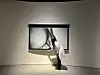 A staff at the Martin Margiela exhibition lowers the projector screen of ″Body Part b&w″ (2018-20) as part of the piece's performance. [SHIN MIN-HEE]