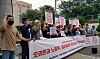 A group of people rally against workplace bullying in front of the Orion factory in Iksan, North Jeolla, on Monday. The group held a press event demanding Orion apologize to the bereaved and arrange measures to prevent similar incidents in the future. [YONHAP]