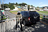 A guard on Sunday afternoon allows a vehicle to pass the security perimeter surrounding Pyeongsan Village in Yangsan, South Gyeongsang, where former President Moon Jae-in's retirement home is located. [YONHAP]