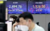Electronic display boards at Hana Bank in central Seoul show Friday markets in Korea. [YONHAP]