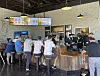People eat Mom’s Touch chicken sandwiches at its first official U.S. store in Los Angeles. [MOM’S TOUCH]