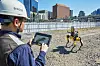 A Hanhwa E&C worker controls a robot dog at the company’s Seoul Station construction site on Sept. 27. [HANWHA ENGINEERING AND CONSTRUCTION]