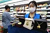 GS25 employees hold up gold products with tiger motifs. According to the Lunar calendar, 2022 is the Year of the Tiger. [YONHAP]