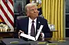 U.S. President Donald Trump signs executive orders in the Oval Office of the White House in Washington, Jan. 20. [AP/YONHAP]