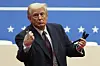 U.S. President Donald Trump throws pens used to sign executive orders to the crowd during an indoor Presidential Inauguration parade event in Washington, Jan. 20. [AP/YONHAP]