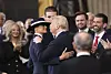 U.S. President Donald Trump, center right, reaches to kiss first lady Melania Trump as Barron Trump, from left, Vice President JD Vance and Donald Trump Jr. watch at the 60th Presidential Inauguration in the Rotunda of the U.S. Capitol in Washington, Jan. 20, 2025. [AP/YONHAP]