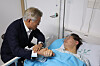 Former President Moon Jae-in, left, holds hands with Democratic Party leader Lee Jae-myung, right, at the Wonjin Green Hospital in Myeonmok-dong, Seoul, on Tuesday.[YONHAP]