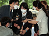 Rep. Yoon Mee-hyang, center, enters the Seoul Southern District Court on Aug. 11 to attend her trial. She was indicted on charges of exploiting survivors of Japan's wartime sexual slavery and misappropriating donations made to her civic group. [YONHAP]