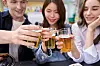 People toast with somaek, one of the most beloved drinks among Koreans and a staple at company gatherings. [GETTY IMAGES]