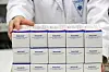 A pharmacist shows boxes of Pfizer's oral pill Paxlovid to treat Covid-19, at a drugstore in Guro District, western Seoul on Sunday. While Korea began administrating the antiviral pills Friday, health authorities said among the nine patients that took the drug on the first day, many of them have showed signs of recovery. [NEWS1]