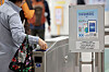 A person passes through a subway turnstile at Gwanghwamun Station in central Seoul on April 7 with a banner advertising the Climate Card unlimited public transportation pass displayed nearby. [YONHAP]