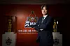 Masaji Ogino poses for a photo in front of the Ansan OK Financial Group Okman logo on Monday. [YONHAP]