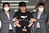 Moon Hyung-wook, the suspected operator of one of the earliest online sex trafficking rings on Telegram, is led out by police for a perp walk in front of the press at the Andong Police Precinct on Monday. [YONHAP]