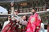 Tourists dressed in hanbok, or traditional Korean dress, take selfies at Gyeongbok Palace in central Seoul on March 3, as visitors enjoyed the last day of a windy long weekend to mark the March 1 Independence Movement holiday. [NEWS1]