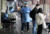 A health worker walks through a Covid-19 testing center in Songpa District, southern Seoul, on Tuesday. [NEWS1]