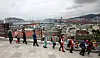 Busan residents walk along the northern harbor of the port city on Wednesday to express their support for the Busan city government's bid to host the World Expo in 2030. [SONG BONG-GEUN]