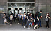 Civil servants at the main Seoul City Hall building in Jung District, central Seoul, evacuate Wednesday afternoon after a worker on the second floor tested positive for the coronavirus. [YONHAP]
