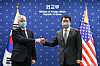 Korean Vice Foreign Minister Choi Jong-kun, left, and U.S. Deputy Secretary of State Stephen Biegun exchange a fist bump ahead of talks at the Foreign Ministry in central Seoul Wednesday. [JOINT PRESS CORPS]