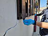 A police officer shows one of the windowsills in the residential area where drug carriers hid the packages of drugs. [GYEONGNAM PROVINCIAL POLICE]