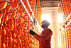 Dried persimmons hang from racks at a farm in Haman County, South Gyeongsang, on Monday. Persimmons are harvested in fall, then dried and sold in December and January. [YONHAP]