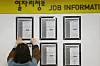 An employee of an employment center in Seoul hanging a job post on the bulletin board on Wednesday. There were 1 million more people employed compared to a year ago in January, which is the first in 22 years. [YONHAP]