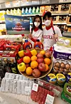 Models pose for a photo to promote the Emart Landers Day sale at an Emart branch in Seongsu-dong, eastern Seoul on Thursday. Emart will be running the Landers Day sale, named after the baseball team it owns, until April 4 to celebrate the start of the KBO season. [YONHAP]
