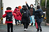 A teacher waves to her students at an elementary school in downtown Seoul Thursday. Earlier in the day, the Education Ministry announced that first and second graders will be able to go to school daily starting next semester if social distancing measures are Level 2 or lower. [NEWS1]