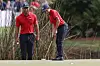 Charlie Woods, right, sinks a putt on the second green while being watched by father Tiger Woods during the second round of the PNC Championship golf tournament on Dec. 19, 2021, in Orlando, Florida. [AP/YONHAP]