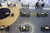 Tables are spaced out at a movie theater in downtown Seoul Wednesday, each with a pamphlet describing sanitation guidelines. [YONHAP]