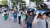 Children hold their school bags over their heads as they take part in a civil evacuation drill at the Central Government Complex in Jongno District, central Seoul, on May 16. [YONHAP]