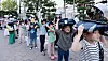 Children hold their school bags over their heads as they take part in a civil evacuation drill at the Central Government Complex in Jongno District, central Seoul, on May 16. [YONHAP]
