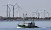 A fisher boat passes wind turbines between the island Langeoog and Bensersiel at the North Sea coast in Germany, in this file photo dated May 15, 2019. Four European Union countries plan to build North Sea wind farms capable of producing at least 150 gigawatts of energy by 2050 to help cut carbon emissions that cause climate change, Danish media reported in May. [AP/YONHAP]