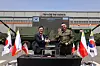 Hanwha Aerospace CEO Son Jae-il, left, and Artur Kuptel, chief of the Polish Armament Agency, shake hands after the contract signing on April 25 at the defense production plant in Changwon, South Gyeongsang. [HANWHA AEROSPACE]