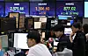 Screens in Hana Bank's trading room in central Seoul show foreign and stock markets open on Tuesday. [YONHAP]
