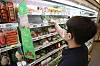 A customer shops at a 7-Eleven in Seoul on Tuesday. Thanks to the government's emergency relief grant, sales of meat and fruit have increased. According to 7-Eleven, sales of meat products between Sept. 7 and Sept. 12 surged 176.2 percent while fruit sales jumped 94.4 percent compared to the previous week. GS25 also saw meat product sales surge 297.7 percent during the same period. [YONHAP]