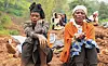 Zeritu Zekarias, 43, sits with her neighbor as her husband and relatives dig in search of the missing son at the site of a landslide of July 22 that buried people in the Gofa zone of southern Ethiopia on Monday. [REUTERS/YONHAP]