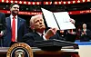 President Donald Trump holds an executive order announcing the United States' withdrawal from the Paris Agreement during the inaugural parade inside Capital One Arena in Washington on Jan. 20. [AFP/YONHAP]