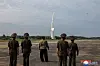 In this photo carried by North Korea's state-run Korean Central News Agency (KCNA), North Korean leader Kim Jong-un and officials look on as the Hwasongpho-11-Da-4.5, a new tactical ballistic missile, is test launched on Wednesday. [YONHAP]