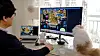 An employee uses RemoteView to demonstrate how to control a desktop computer using a laptop . [SCREEN CAPTURE]