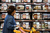 A customer examines meal kits on the shelves of a discount store in Seoul, Wednesday. Meal kits are becoming popular with a growing number of people who opt to cook at home rather than eat out. Sales of kits shot up 238.8 percent on year in September, according to local retail chain Emart. [YONHAP]