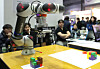 Visitors look at a robotic arm at an industrial technology exhibition in Coex in southern Seoul in 2019. [YONHAP]