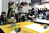 Visitors look at a robotic arm at an industrial technology exhibition in Coex in southern Seoul in 2019. [YONHAP]