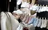 A customer takes a look at some infant socks at a baby products fair in Ilsan, Gyeonggi, on May 4. [NEWS1]