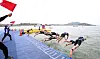Swimmers dive into water at the 53rd National Junior Sports Festival Triathlon held in Muan County, North Jeolla, in May. [NES1]