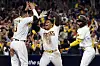 Kim Ha-seong of the San Diego Padres, right, celebrates with teammates Juan Soto, center, and Manny Machado after scoring two runs during the seventh inning to go up 5-3 against the Los Angeles Dodgers in game four of the National League Division Series at Petco Park in San Diego on Saturday. Kim batted in the tying run as the Padres went on to beat the Dodgers 5-3 to win the NLDS and advance to the National League Championship Series, where they will face the Philadelphia Phillies. [AFP/YONHAP]