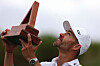 Camilo Villegas of Colombia celebrates with the trophy after winning the Butterfield Bermuda Championship at Port Royal Golf Course on Nov. 12, 2023 in Southampton, Bermuda. [GETTY IMAGES]