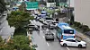 Cars abandoned by their drivers due to heavy rain the previous night are strewn across a road in Seocho-dong, Gangnam, on Tuesday. [YONHAP]