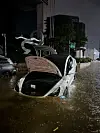 An abandoned Tesla half submerged in Seocho-dong, Gangnam, on Monday. [MICHAEL LEE]